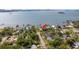 Aerial view showcases the property's location with waterfront access, nearby docks, and lush greenery at 1748 Sunset Dr, Clearwater, FL 33755