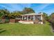 Inviting backyard featuring a spa, covered patio with ample seating, and a well-manicured lawn at 1748 Sunset Dr, Clearwater, FL 33755