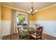 Charming dining room with a glass table, chandelier, and a backyard view at 1748 Sunset Dr, Clearwater, FL 33755