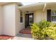 Inviting front entrance with a decorative glass door, brick steps and lush landscaping at 1748 Sunset Dr, Clearwater, FL 33755