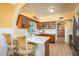 Bright eat-in kitchen featuring tiled floors, wooden cabinets, and stainless steel appliances at 1748 Sunset Dr, Clearwater, FL 33755