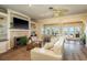 Spacious living room with a fireplace, built-in shelves, and a view of the water at 1748 Sunset Dr, Clearwater, FL 33755