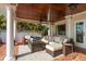 Covered patio with tile flooring, ceiling fan, and comfortable outdoor seating area at 1748 Sunset Dr, Clearwater, FL 33755