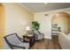Relaxing sitting area with arched entryways, patterned chairs, and natural light at 1748 Sunset Dr, Clearwater, FL 33755