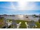 Waterfront backyard with chairs, a pier, and a beautiful view of the water at 1748 Sunset Dr, Clearwater, FL 33755