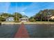Waterfront property with a private dock and lush landscaping, accessible from the backyard at 1748 Sunset Dr, Clearwater, FL 33755
