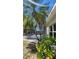 Lush landscaping and private backyard oasis with mature palm tree at 2113 E Del Webb Blvd, Sun City Center, FL 33573