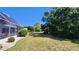 Manicured backyard with a screened lanai and lush green landscaping at 2113 E Del Webb Blvd, Sun City Center, FL 33573
