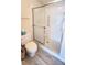 Modern bathroom featuring tiled floors, a toilet, and a shower with sliding glass doors at 2113 E Del Webb Blvd, Sun City Center, FL 33573