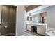 Modern bathroom featuring dual sinks, vanity area, and views of the adjacent tub and shower at 2113 E Del Webb Blvd, Sun City Center, FL 33573