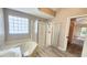 Well-lit bathroom featuring a separate shower, soaking tub, and stylish flooring at 2113 E Del Webb Blvd, Sun City Center, FL 33573