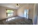 Bright bedroom featuring neutral paint, large windows, and plush carpet at 2113 E Del Webb Blvd, Sun City Center, FL 33573