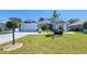 Charming single-story home boasts a well-manicured lawn, front-entry garage, and delightful landscaping at 2113 E Del Webb Blvd, Sun City Center, FL 33573