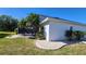 Charming single-Gathering home exterior featuring a lush, green lawn at 2113 E Del Webb Blvd, Sun City Center, FL 33573