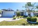 Attractive home featuring a tidy front yard and a well-lit driveway at 2113 E Del Webb Blvd, Sun City Center, FL 33573