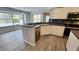 Bright kitchen with stainless steel appliances, white cabinetry, and gray countertop at 2113 E Del Webb Blvd, Sun City Center, FL 33573