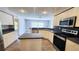 Modern kitchen featuring stainless steel appliances, white cabinets, gray countertops, and eat-in bar at 2113 E Del Webb Blvd, Sun City Center, FL 33573