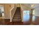 View of the living room and carpeted stairs leading up to the home's second level at 2113 E Del Webb Blvd, Sun City Center, FL 33573