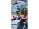 A covered patio has comfortable seating around a small fire pit, ideal for outdoor relaxation and entertainment at 2113 E Del Webb Blvd, Sun City Center, FL 33573