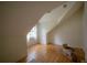 A bright and airy attic space with hardwood flooring and a window providing natural light at 2305 S Hesperides St, Tampa, FL 33629