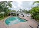 Spacious backyard with a refreshing pool, covered patio, and well-maintained landscaping, ideal for outdoor enjoyment at 2305 S Hesperides St, Tampa, FL 33629