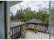 View of lush landscaping from the wooden balcony with dark railings at 2305 S Hesperides St, Tampa, FL 33629