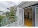 Balcony with chairs leading to a room needing renovation at 2305 S Hesperides St, Tampa, FL 33629