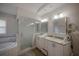 Modern bathroom features double vanity, shower, tub and tile flooring at 2305 S Hesperides St, Tampa, FL 33629
