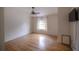 Bright bedroom featuring hardwood floors, a ceiling fan, and a large window with curtains at 2305 S Hesperides St, Tampa, FL 33629