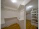 Walk-in closet offers ample storage space with built in shelving and plenty of room to hang clothes at 2305 S Hesperides St, Tampa, FL 33629