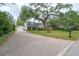 Elegant home featuring a brick driveway leading to a well-maintained two-story house with a spacious front yard at 2305 S Hesperides St, Tampa, FL 33629