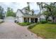 Beautiful brick home with manicured landscaping, brick driveway, and a detached two-car garage at 2305 S Hesperides St, Tampa, FL 33629
