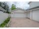 Spacious two-car garage with brick driveway and potential for additional storage at 2305 S Hesperides St, Tampa, FL 33629