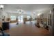 Large living room featuring brick floors, ceiling fans, and natural light at 2305 S Hesperides St, Tampa, FL 33629