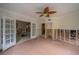 Living area with French doors and a ceiling fan, currently under renovation at 2305 S Hesperides St, Tampa, FL 33629