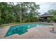 Relaxing backyard with a private pool, brick patio, and covered outdoor living area, perfect for entertaining at 2305 S Hesperides St, Tampa, FL 33629