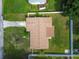 Aerial view of the house and its backyard, highlighting the roof and surrounding landscaping at 2401 Havana Dr, Clearwater, FL 33764