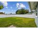 Spacious backyard with a well-maintained lawn and a privacy fence, perfect for outdoor activities at 2401 Havana Dr, Clearwater, FL 33764