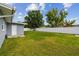 Large backyard with a white fence, providing privacy and ample space for recreation at 2401 Havana Dr, Clearwater, FL 33764