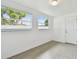 This light-filled bedroom features modern tile flooring and two sun-filled windows at 2401 Havana Dr, Clearwater, FL 33764