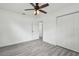 Spacious bedroom with gray flooring, walk in closet and white trim, offering comfortable living space at 2401 Havana Dr, Clearwater, FL 33764