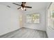 Bedroom with gray flooring, ceiling fan, and bright window; a cozy and inviting space at 2401 Havana Dr, Clearwater, FL 33764