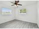 Sunlit bedroom with gray floors, enhancing comfort and bright living space at 2401 Havana Dr, Clearwater, FL 33764