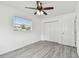 Bright bedroom with a ceiling fan, window, and closet; clean, modern, and ready for personalization at 2401 Havana Dr, Clearwater, FL 33764