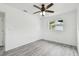 Bright bedroom featuring gray vinyl flooring and a window for natural light at 2401 Havana Dr, Clearwater, FL 33764