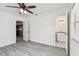 Bright bedroom featuring ceiling fan, wood-look floors, and ensuite bathroom at 2401 Havana Dr, Clearwater, FL 33764