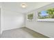Bright bedroom with ample natural light from dual windows and modern tile flooring at 2401 Havana Dr, Clearwater, FL 33764