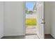 Bright entryway with white door leads to the backyard and green lawn at 2401 Havana Dr, Clearwater, FL 33764