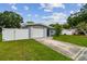 Charming single-story home features a lush front yard, long driveway, and attached garage at 2401 Havana Dr, Clearwater, FL 33764