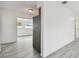 View of an adjacent living space from the kitchen, featuring gray vinyl flooring at 2401 Havana Dr, Clearwater, FL 33764